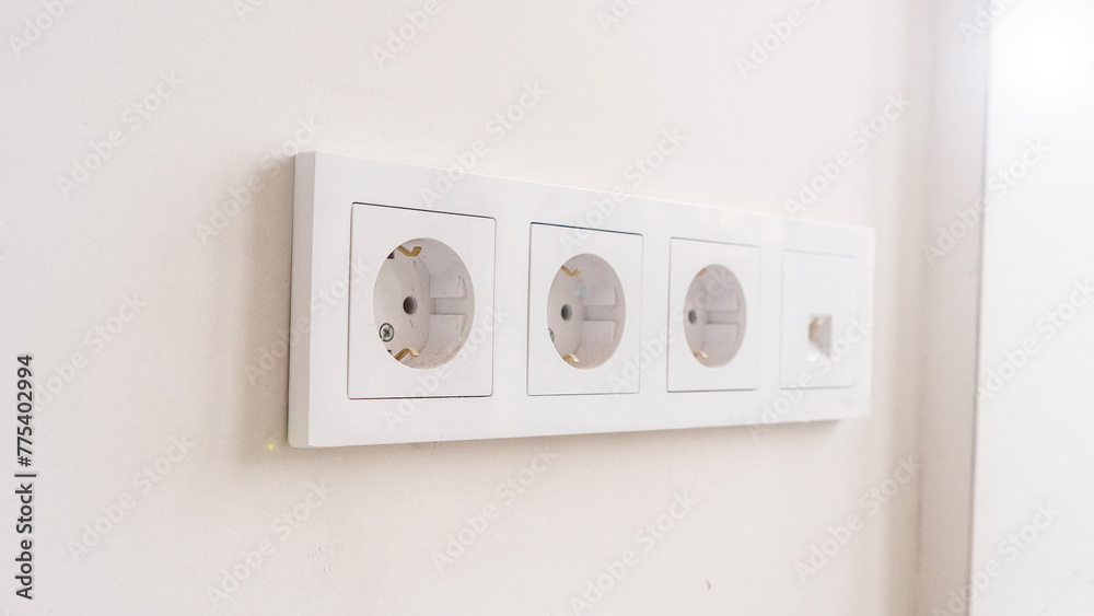 Close-up shot of a double european electrical socket isolated on a white wall. Renovation in a new apartment Close-up shot of a double european electrical socket isolated on a white wall. Renovation in a new apartment