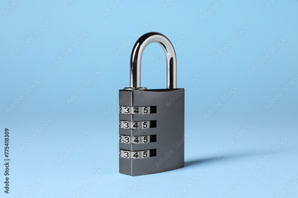 Steel combination padlock on light blue background Steel combination padlock on light blue background