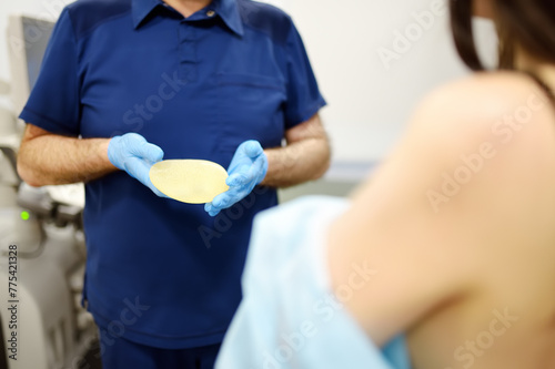 A young woman at a mammologist's appointment. Consultation on breast shape correction - lifting, reduction, reconstruction, enlargement, implants. Breast cancer. Cosmetic Plastic Surgery