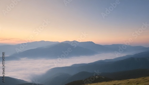 peaceful blue nature background with foggy bucegi mountains in carpathians seen from cota 2000 sinaia resort romania photo