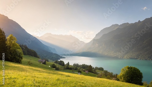 idyllic swiss nature landscape green meadows surrounded by alps mountains scenic lake brienz iseltwald village