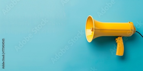 A yellow microphone is on a blue background. The microphone is the main focus of the image, and it conveys a sense of excitement and energy