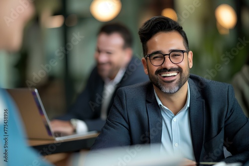 Portrait of smiling hispanic young businessman working with middle aged business man at office meeting, sitting in modern boardroom and discussing project using laptop computer. generative AI