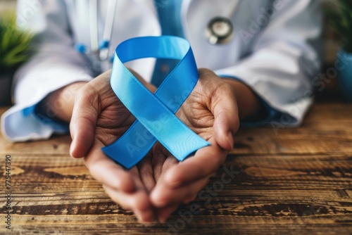 A doctor holds a blue ribbon in his hand