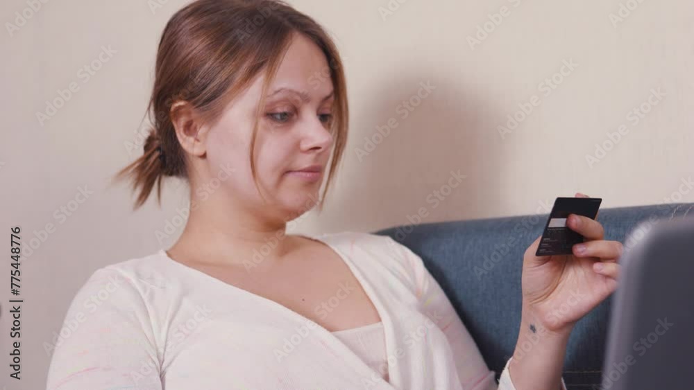 Young woman using laptop shopping online home paying with credit card. Young woman using laptop shopping online home paying with credit card.