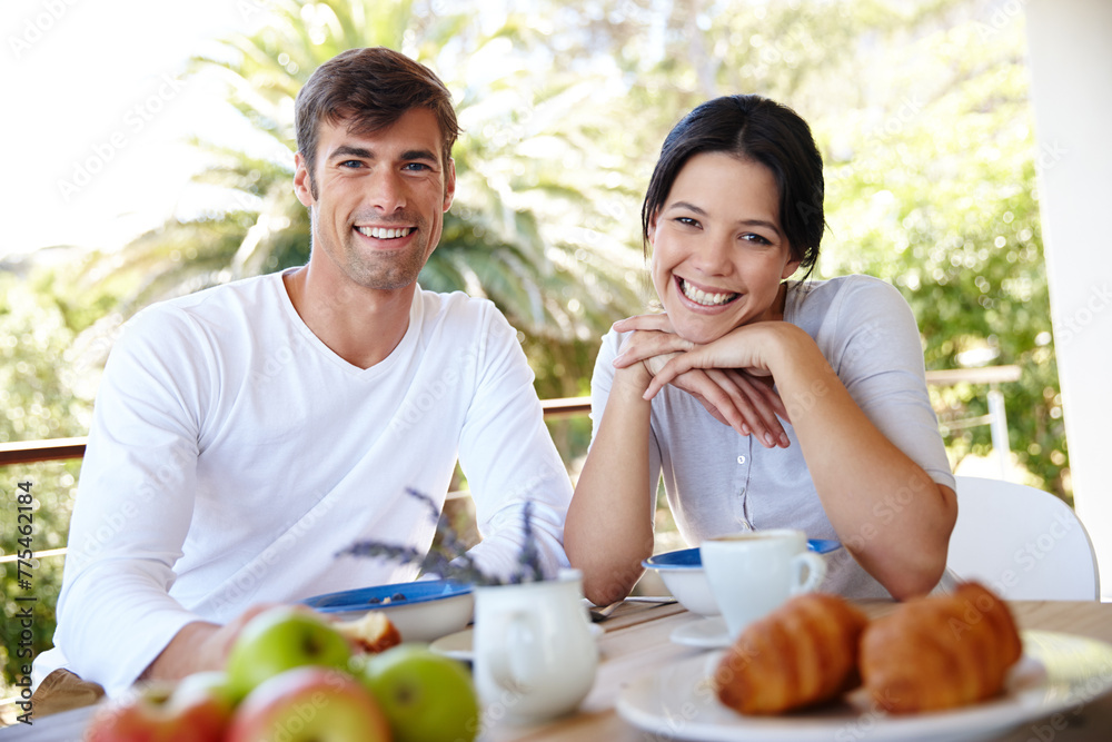 Couple, balcony and outdoor portrait for meal, love and affection in marriage or romance in nature. People, nutrition and smile at breakfast for healthy relationship, food and relax on vacation
