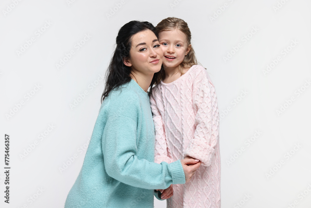 Beautiful mother with little daughter on white background Beautiful mother with little daughter on white background