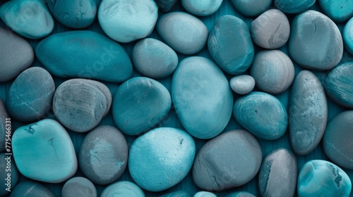 Beach pebbles. Blue, green and turquoise toned stones. Beautiful nature background image on black. Layer of pretty aesthetic rocks. Creativity with natural objects. Creative art design project idea