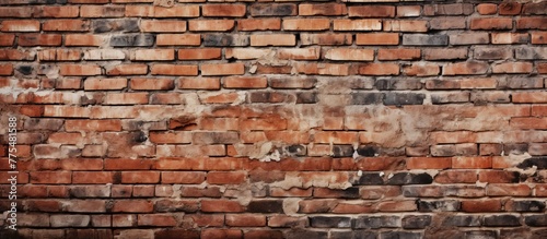 A detailed view of a weathered brick wall showing multiple cracks and signs of wear and tear