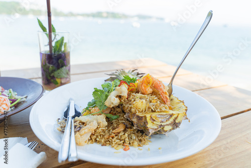 Seafood fried rice in pineapple, appetizing in a cafe next to the sea, Sue Flamingo, Ao Yon Beach, Phuket Thailand