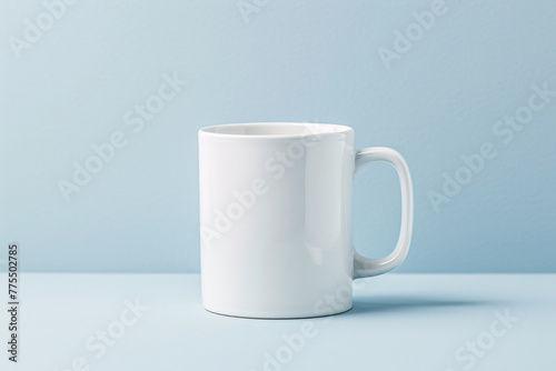 A lone white ceramic coffee cup sits empty on a wooden table