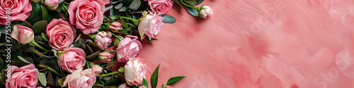 Bunch of pink roses on a pink wall adding a pop of color and charm to the space. Banner. Copy space. Background. photo