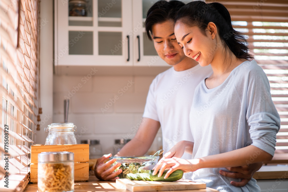 Asian young new marriage couple spend time together in kitchen at home. Asian young new marriage couple spend time together in kitchen at home.