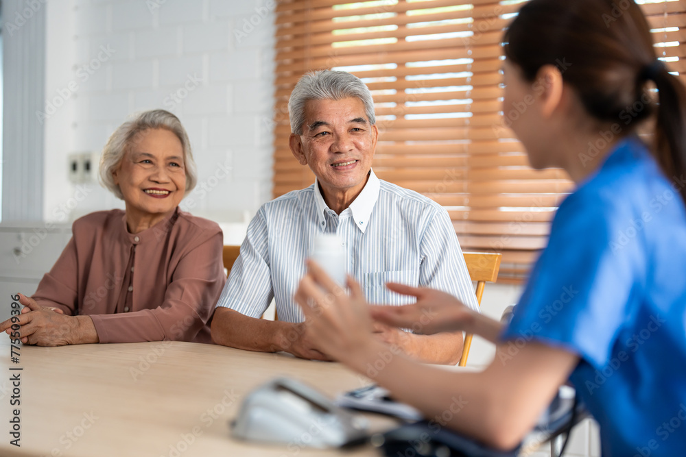 Obraz premium Asian caregiver nurse examine senior man and woman patient at home. 