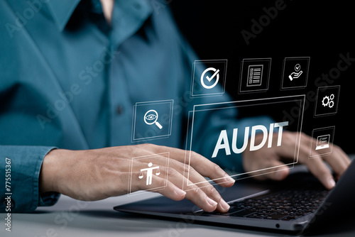 Audit business concept. Businessman using laptop to audit and evaluate corporate financial statements. Auditing financial accounts within the organization.