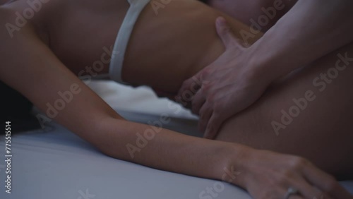 Close up of sensual man and woman making love on bed in bedroom at home. 