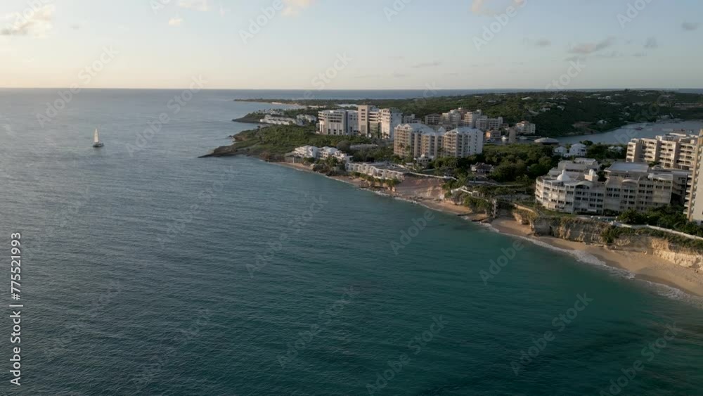 Cupecoy Saint Martin Coastline. Aerial Drone Push-in with small sail-boat in Caribbean sea Cupecoy Saint Martin Coastline. Aerial Drone Push-in with small sail-boat in Caribbean sea
