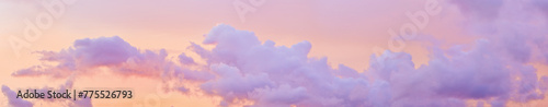 Aesthetic Pastel Sunset, violet fluffy clouds on pink peach colored sky, dreamy cloudscape pastel tones, surreal dreamscape at sunset, soft colorful heaven, wide banner, panoramic view. © yrabota