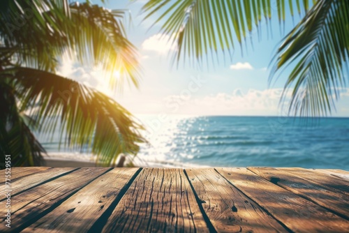Wooden table overlooking the sea, palm trees and bokeh - blurry light of the sea and sky against the backdrop of a tropical beach. Empty space for product display