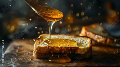 The honey drips from a spoon onto a slice of toast. photo