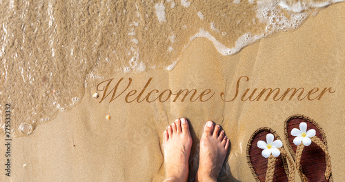 Welcome summer background idea, girl standing on sandy beach with jute sandals and plumeria flower, banner style