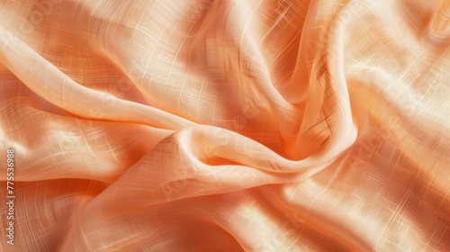 Detailed view of a warm peach-colored fabric material, suitable for luxury goods advertising. Background.