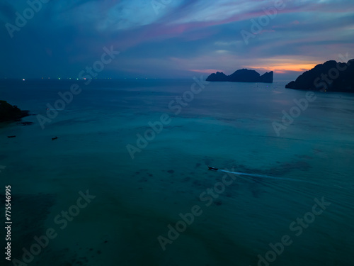 A stunning sunset over a small Phi Phi islands surrounded by sea and clouds © Amazing Travel Stock