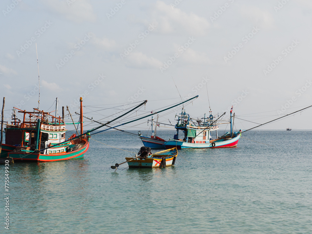 Fishing boat anchored against a clear sky. Sunny day. No people, outdoors. Concept of leisure and travel Fishing boat anchored against a clear sky. Sunny day. No people, outdoors. Concept of leisure and travel