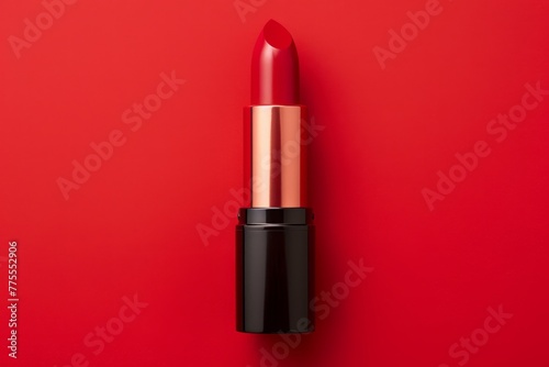 Red lipstick on a red background, flat lay. Top view 