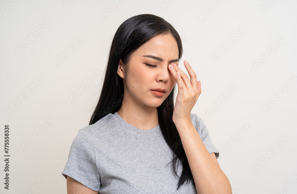 Young asian beautiful woman hand rubbing eyes she's feeling depressed stress headache be tired from working standing on isolated white background she has unwell unhealthy problems. Young asian beautiful woman hand rubbing eyes she's feeling depressed stress headache be tired from working standing on isolated white background she has unwell unhealthy problems.