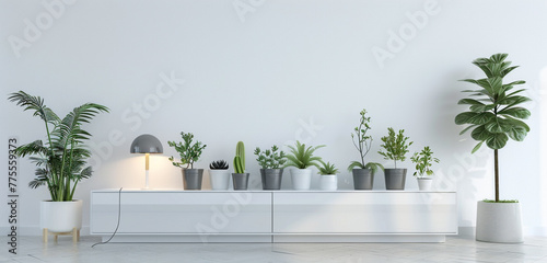 A sleek and modern TV cabinet with glossy white finish, adorned with a variety of plants in pots and a minimalist lamp, against a white wall background