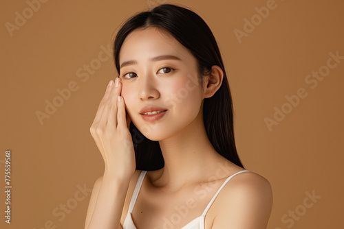 Wallpaper Mural A skincare commercial for an Asian woman with straight hair wearing a white tank top against a brown background Torontodigital.ca