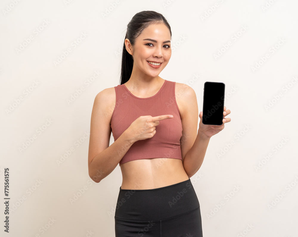 Young beautiful asian woman with sportswear using smartphone on isolated white background. Attractive Portrait latin sporty woman standing pose holding cell phone exercise workout in studio. Young beautiful asian woman with sportswear using smartphone on isolated white background. Attractive Portrait latin sporty woman standing pose holding cell phone exercise workout in studio.