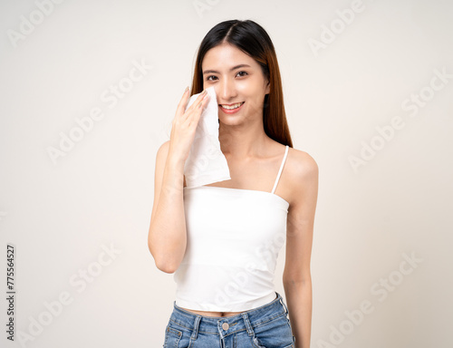 A woman wipes her face clean of cosmetics with tissue paper. Beautiful asian woman cleaning removal Skincare face wash after make up