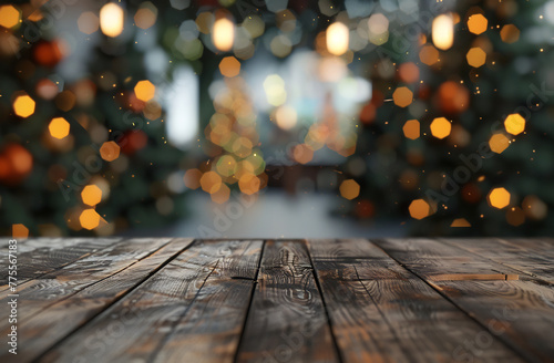 A blurred background of Christmas trees with a bokeh effect and empty wood table