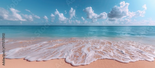 Beautiful white sand beach and calm waves of the turquoise ocean on a sunny day on the background of white clouds in the blue sky. Beautiful colors. Natural landscape.