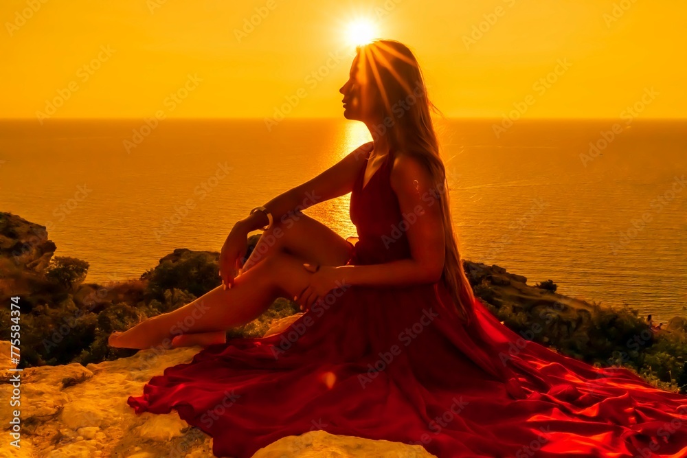 Woman sunset sea red dress, portrait happy beautiful sensual woman in a red long dress posing above the sea on sunset.