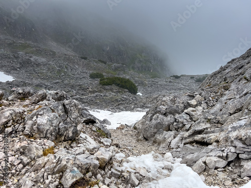 A walk though the Berchtesgaden snow fields during a foggy and cloudy summer day