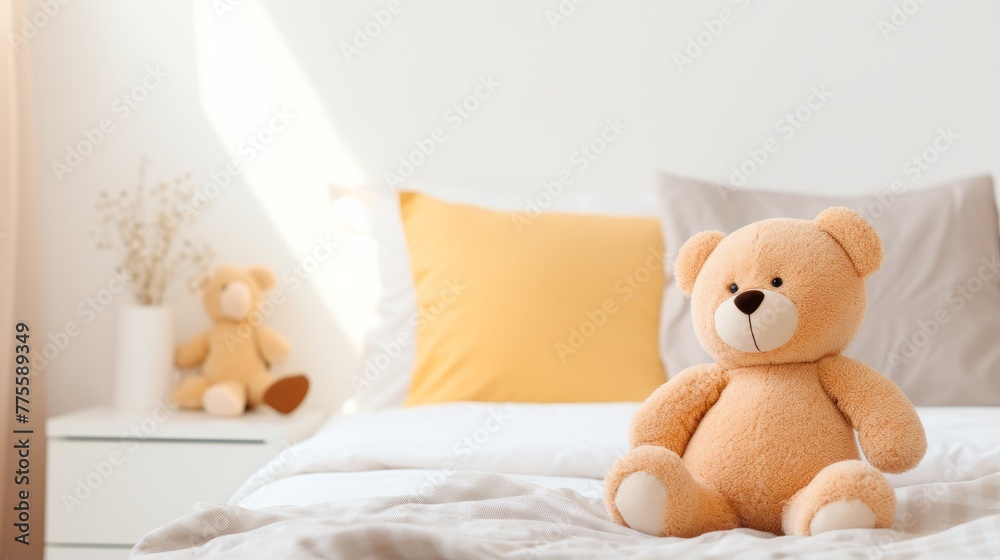 A cute teddy bear sitting on a bed with a white background