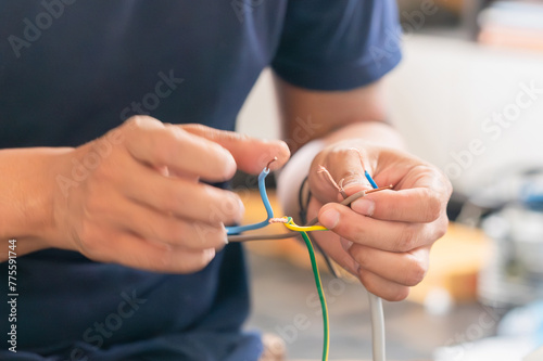 Technician man connecting electric wires to install new air conditioning, repair service, and install new air conditioner concepts photo