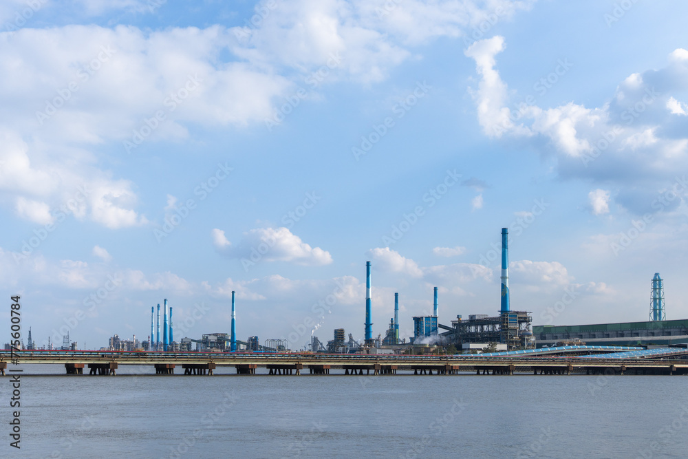 A factory with chimneys towering by the seaside with tall chimneys A factory with chimneys towering by the seaside with tall chimneys