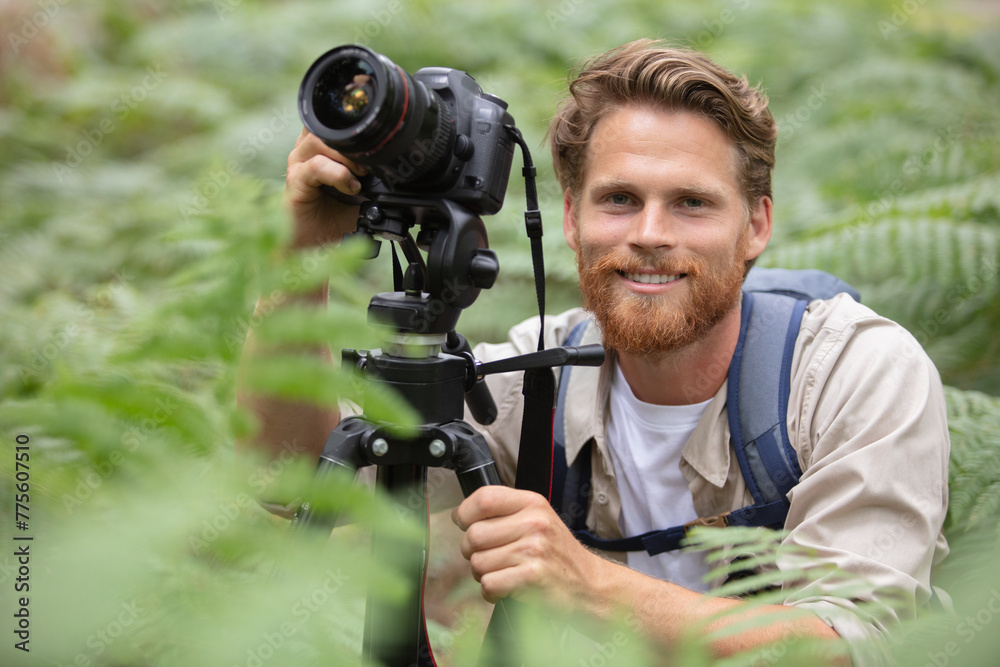 nature photographer with camera and tripod taking photos nature photographer with camera and tripod taking photos