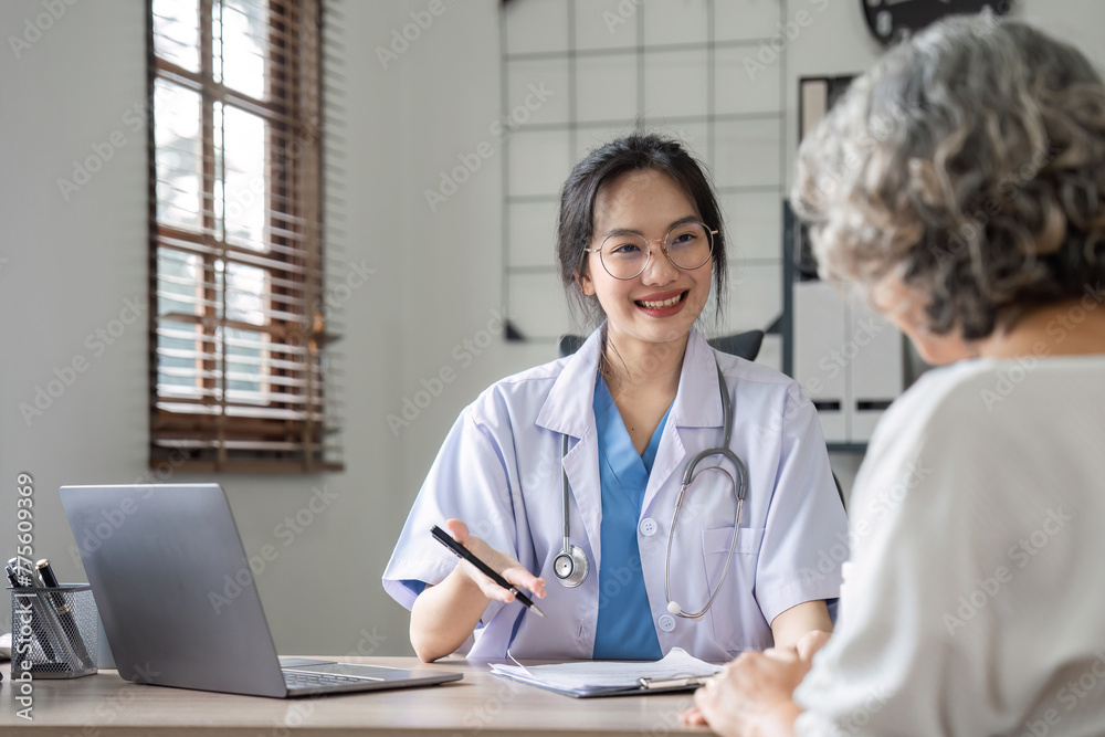 A beautiful female doctor is sitting giving health advice and encouragement in taking care of her health to an elderly retired woman with health problems. A beautiful female doctor is sitting giving health advice and encouragement in taking care of her health to an elderly retired woman with health problems.
