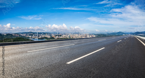 Asphalt highway road and city skyline with green mountains natural landscape in Shenzhen. Panoramic view.