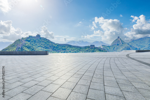 Empty square floor and the Great Wall of China. Road and mountain with ancient buildings background.