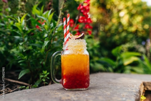 Passion Fruit Mocktail in a Garden: Refreshing Non-Alcoholic Beverage Surrounded by Lush Greenery and Vibrant Flora photo