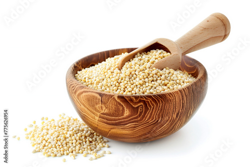 Raw millet grains in brown wooden bowl with scoop isolated on white background photo