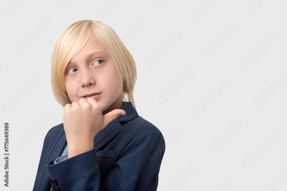 Thoughtful blond schoolboy with short haircut, keeps hand on chin, ponders something, isolated over white background. Thoughtful blond schoolboy with short haircut, keeps hand on chin, ponders something, isolated over white background.