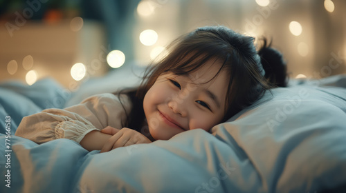 Serene child lying in bed with twinkling lights