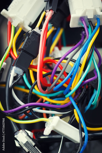 The mess of various tangled wires and connectors. Colorful cables of electronic device with bad montage.